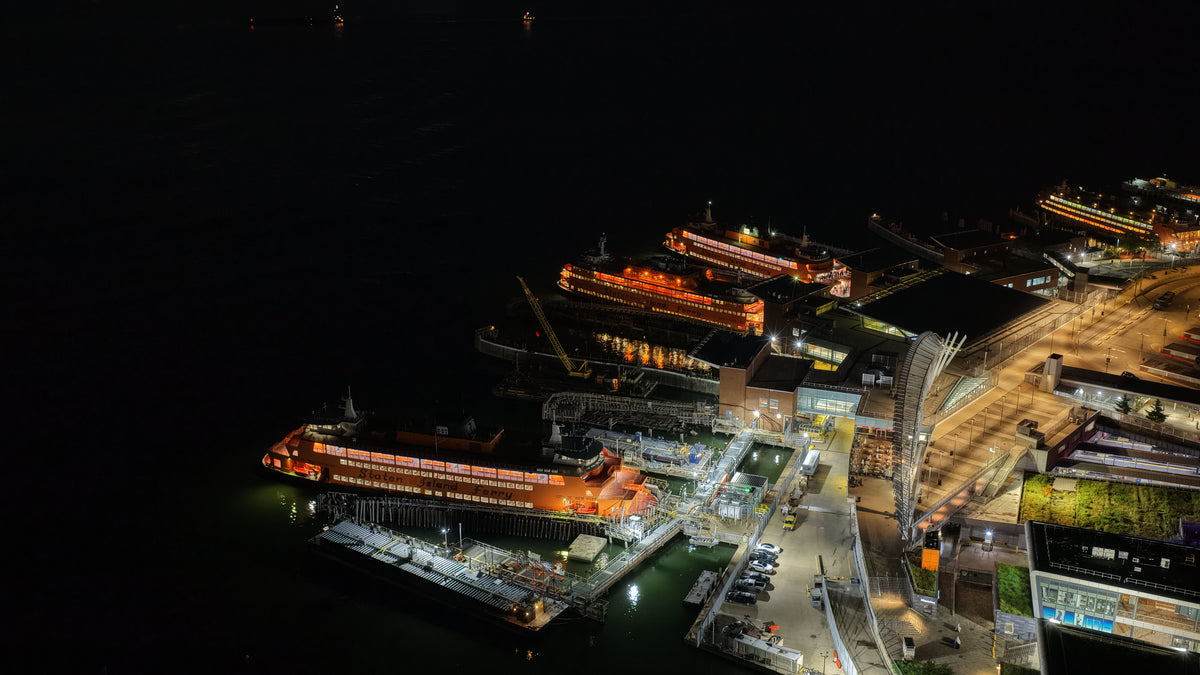Staten Island ferries docked beside the waterfront at night